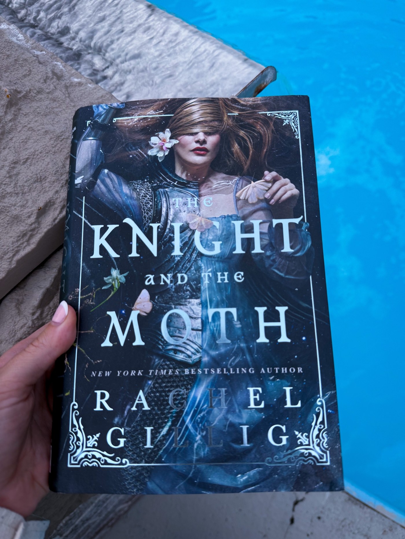 The knight and the moth by rachel gillig behind held over a rock waterfall into a pool.